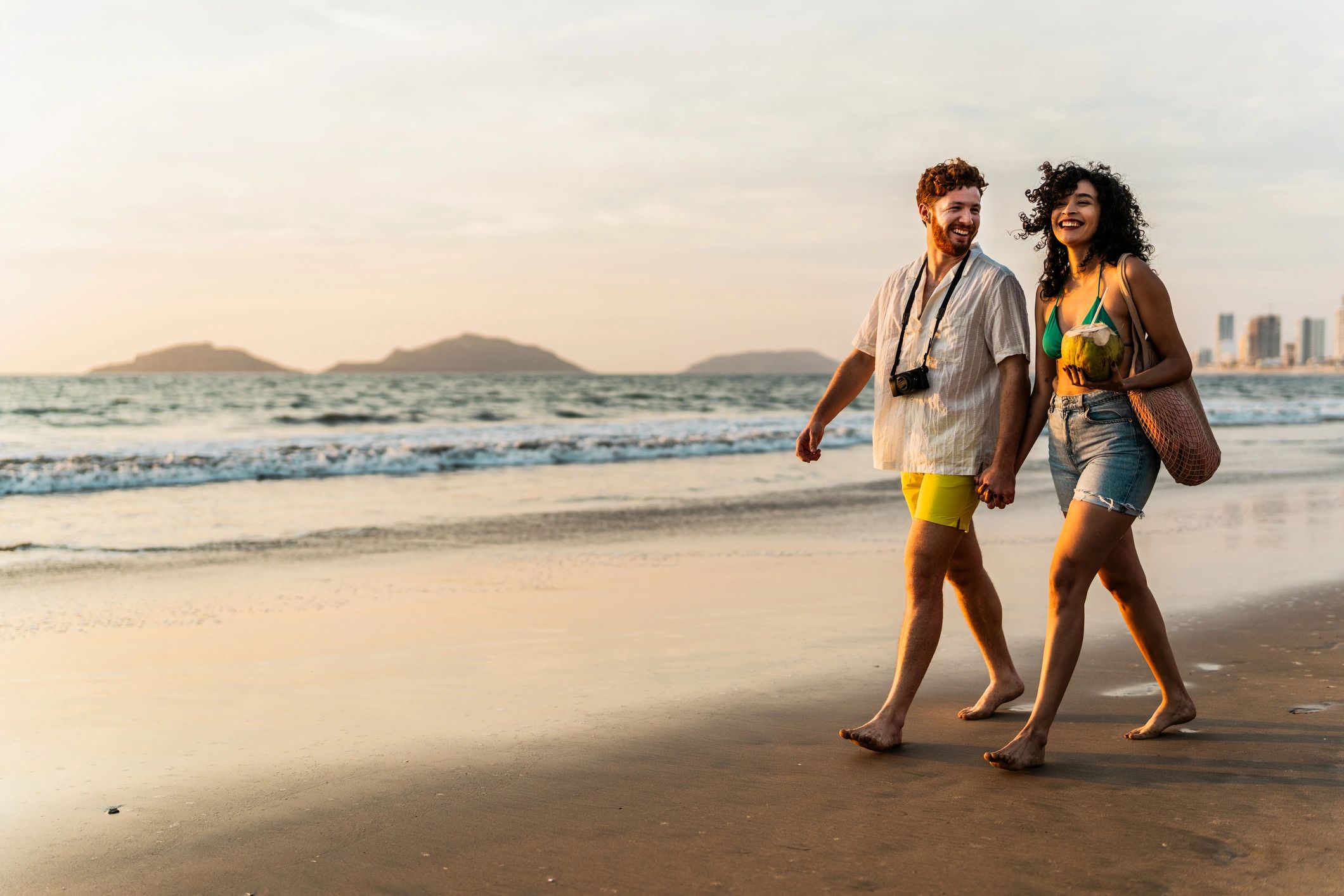 Travelers walking along a scenic shoreline